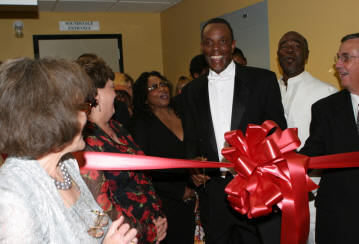 Ralph Wilcox cuts the ribbon for the new studio